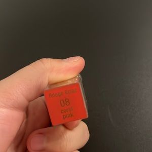 Small, coral pink lipstick Brand:Clarins
